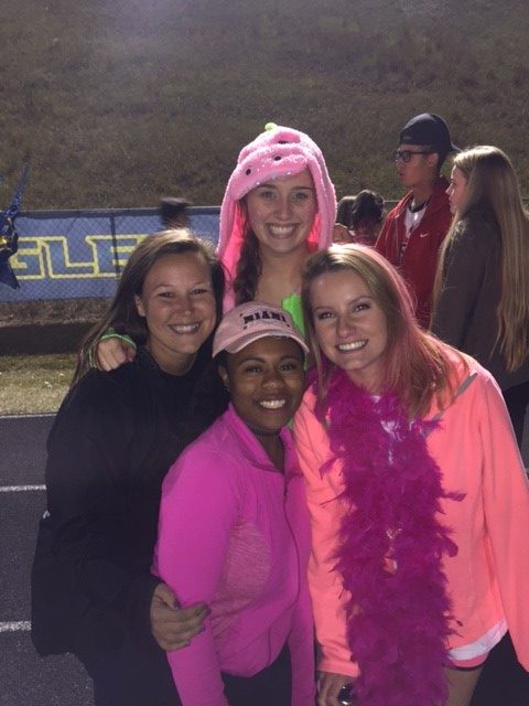 Mrs. Massey (left) with students at a football game